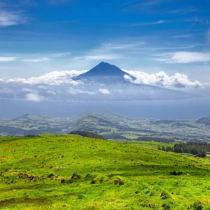 Scenic view of Faial Island featuring Pico Mountain under a cloudy sky.