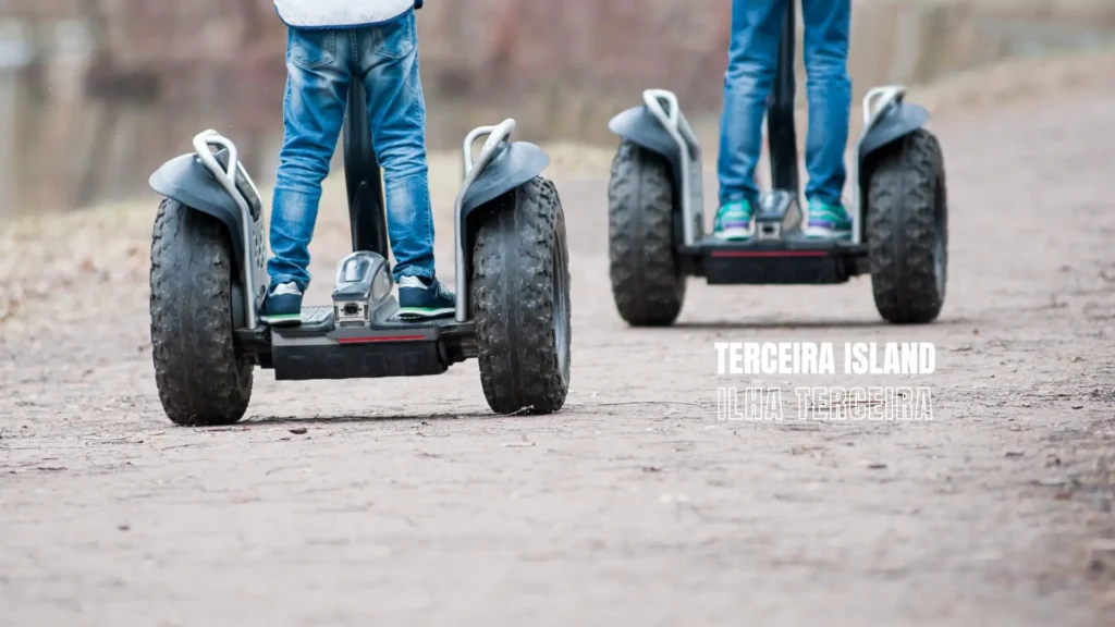 Two individuals riding Segways on a path, with focus on their legs and the Segway devices.
