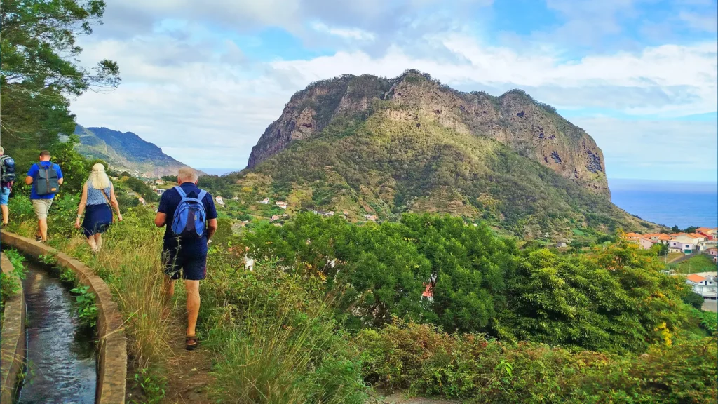 Group of hikers walking along a path with Castelejo Mountain in the background.